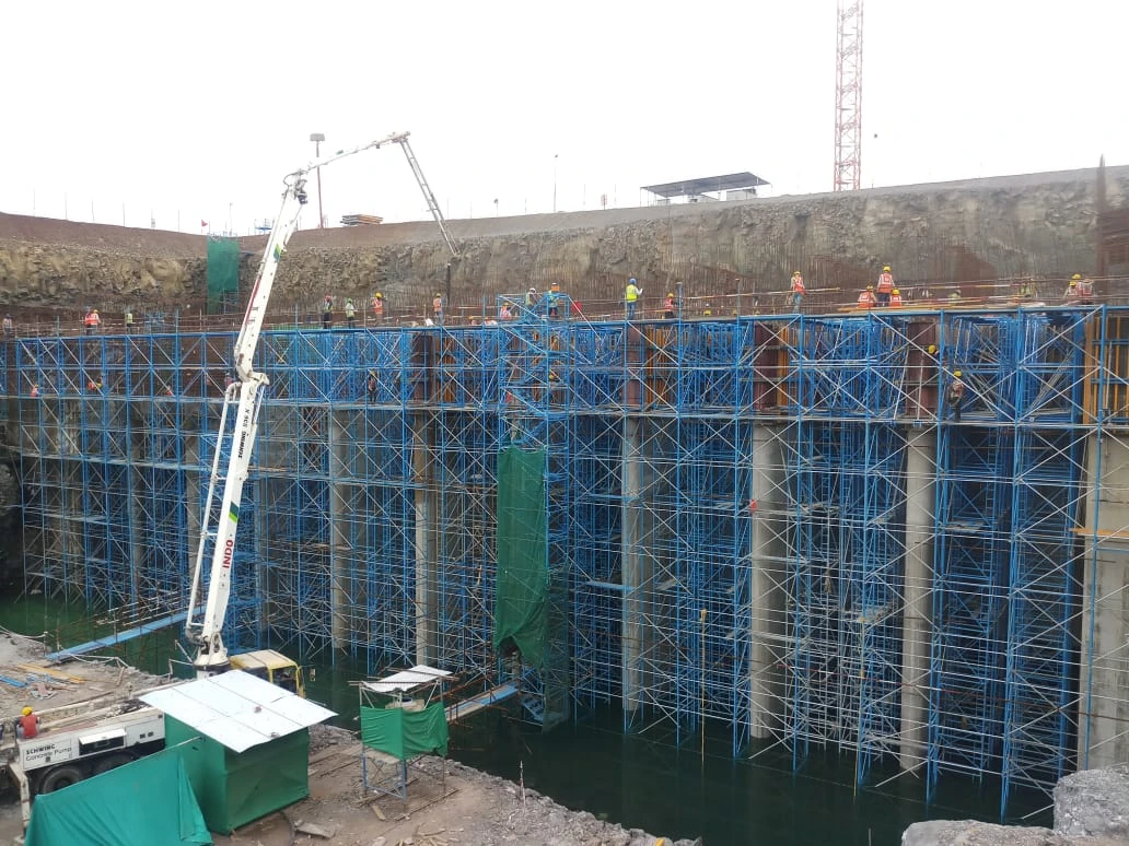 Large concrete structure under construction, with formwork, reinforcement and scaffolding